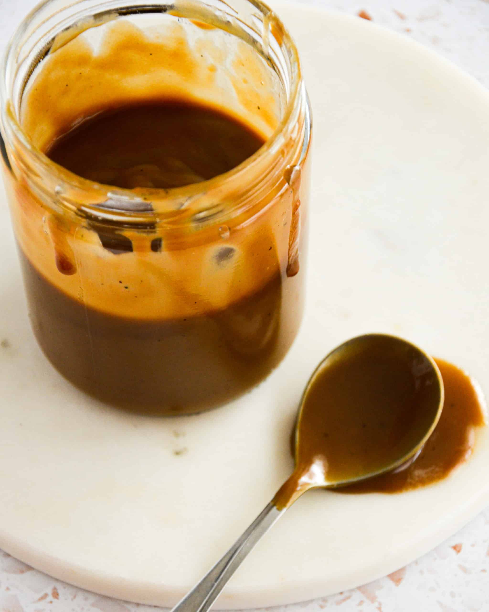 a mason jar filled with vegan salted caramel dripping from the sides