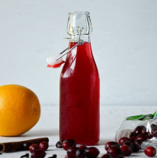 Spiced-Orange-Cranberry-Simple-Syrup-in-Jar-Straight-On-with-Props