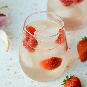 rounded glass filled with rose sangria and strawberries