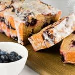 Lemon Blueberry Bread slices with fresh blueberries on the side