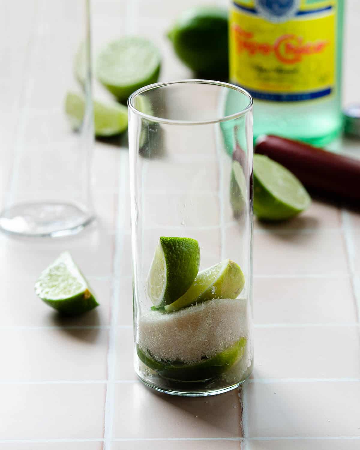 Limes and sugar in a glass for a mojito. 