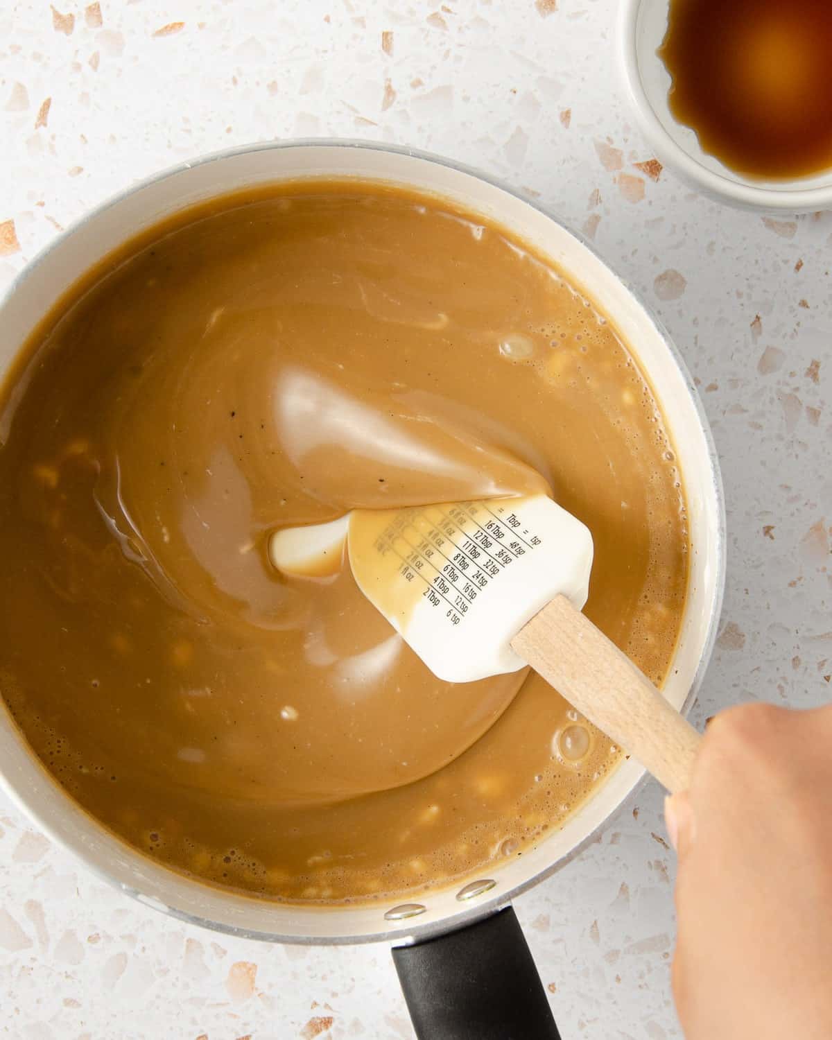 smoothing the ingredients for vegan salted caramel in a small pot.