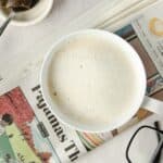 A close up of a London Fog Tea Latte on top of a newspaper.