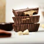 A featured image of a close up of three cashew butter cups stacked vertically.