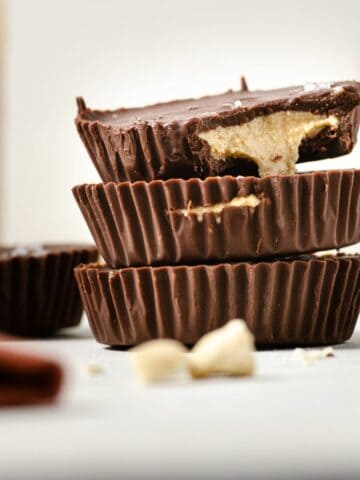 A featured image of a close up of three cashew butter cups stacked vertically.
