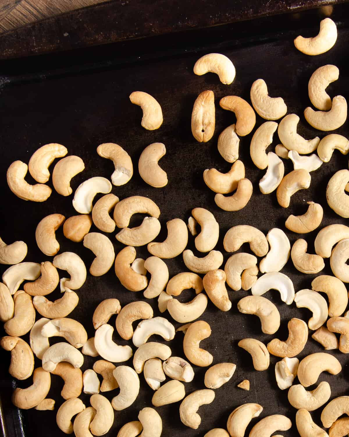 Roasted cashews on a baking tray.