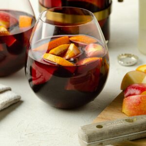 Close up of a round glass of red wine sangria.