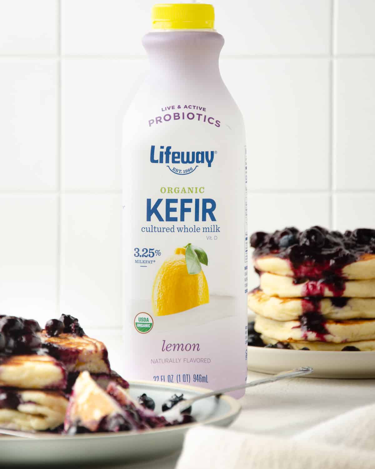 A bottle of Lifeway Kefir lemon flavored kefir milk among pancakes.