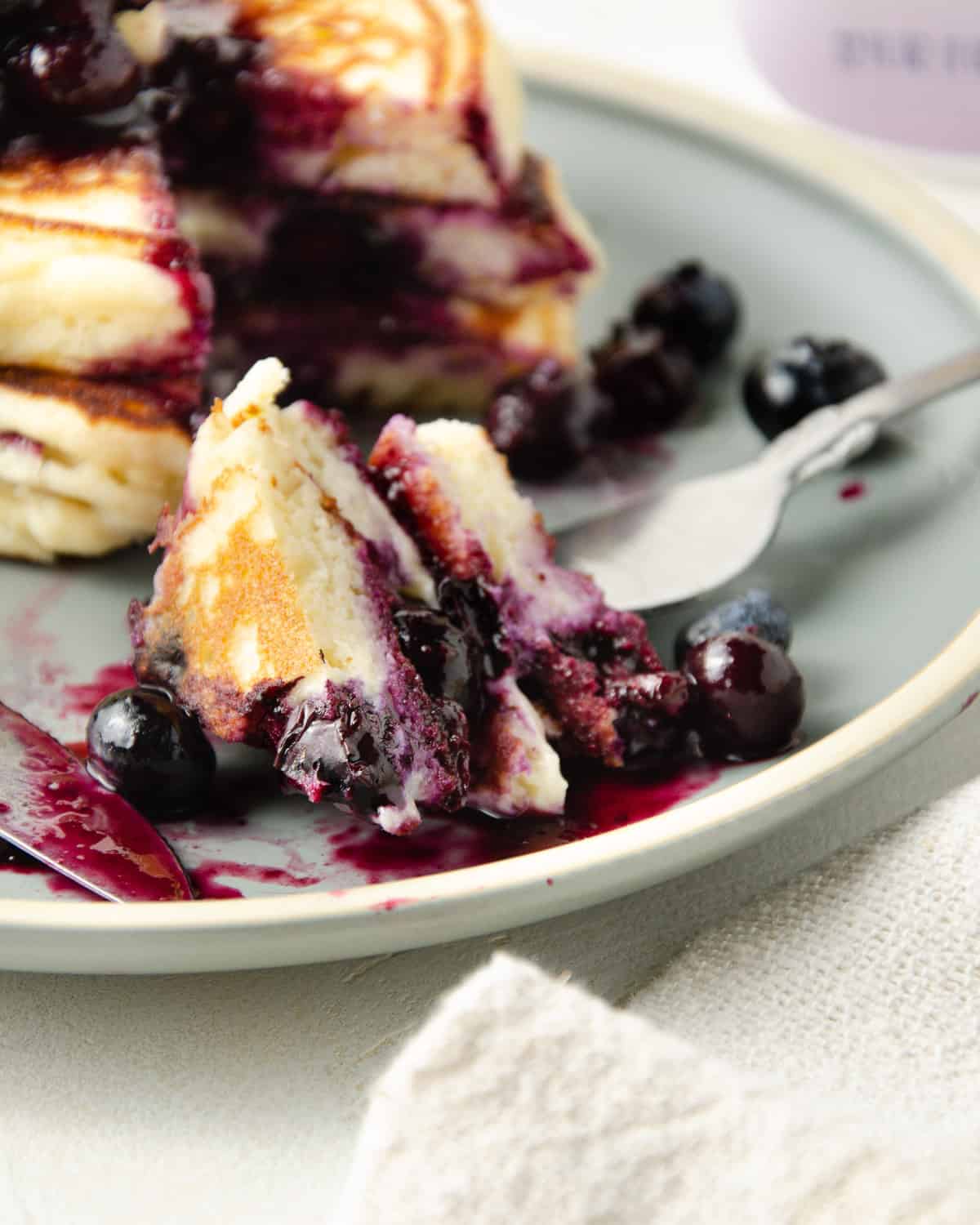 Close up of lemon blueberry pancakes on a fork.