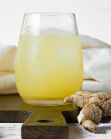 A close up of pineapple ginger juice in a small glass.