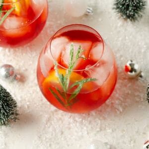 Featured image of a Winter Aperol Spritz in a glass with rosemary and orange garnish.