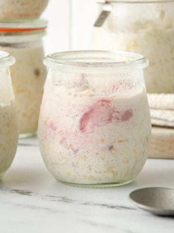 A jar of overnight protein oats with strawberry slices.