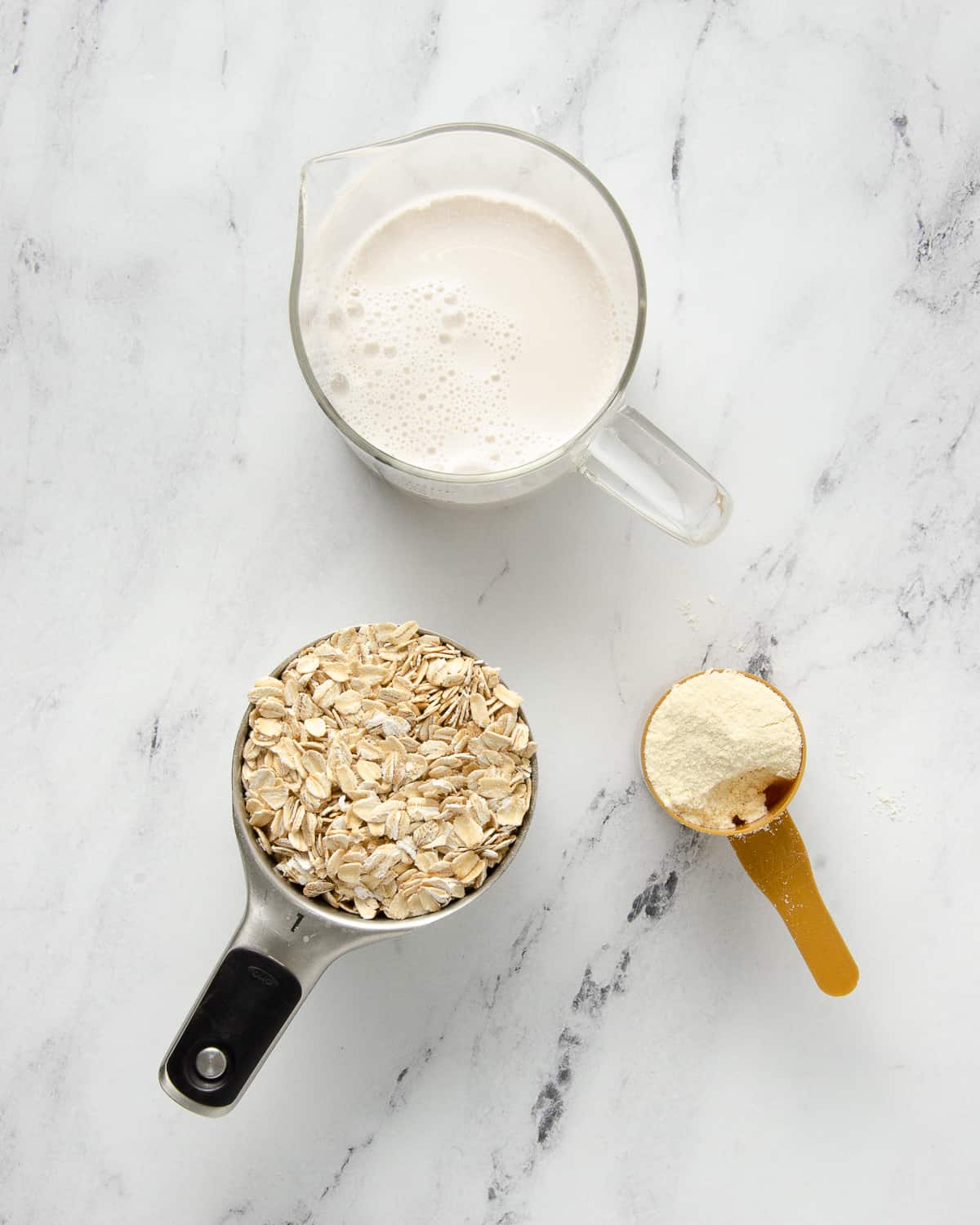 Ingredients needed for overnight protein oats: dairy free milk, rolled oats, and protein powder. 