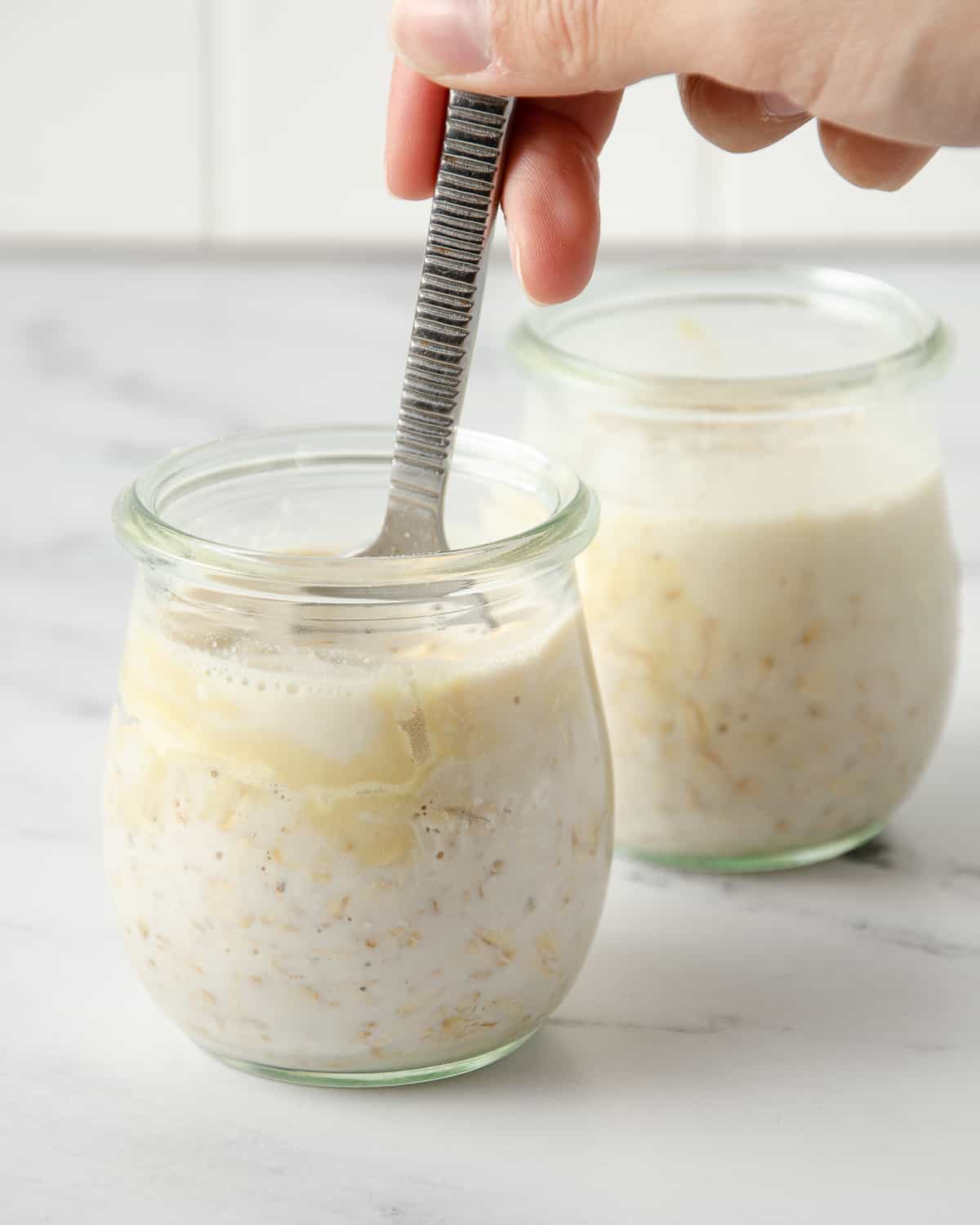 A spoon mixing the overnight protein oats.