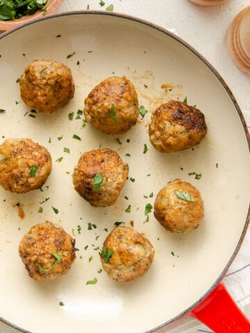 Overhead view of gluten free meatballs seared in a pan.