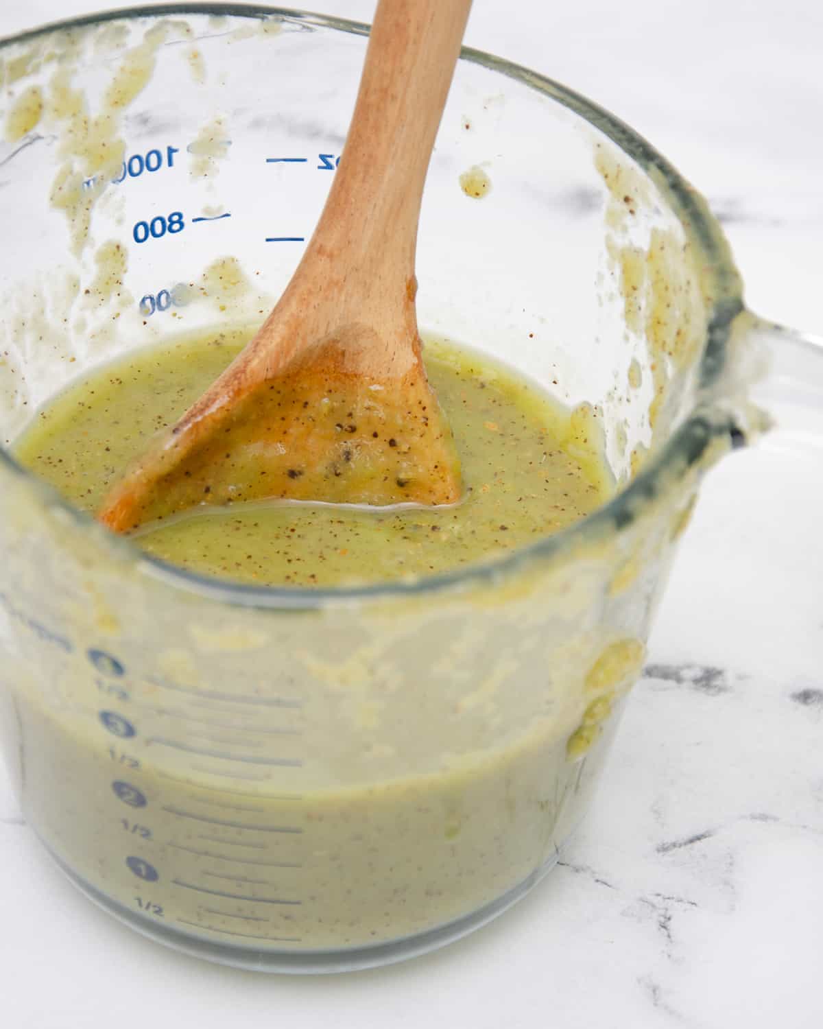 Glass measuring cup with strained kiwi puree.