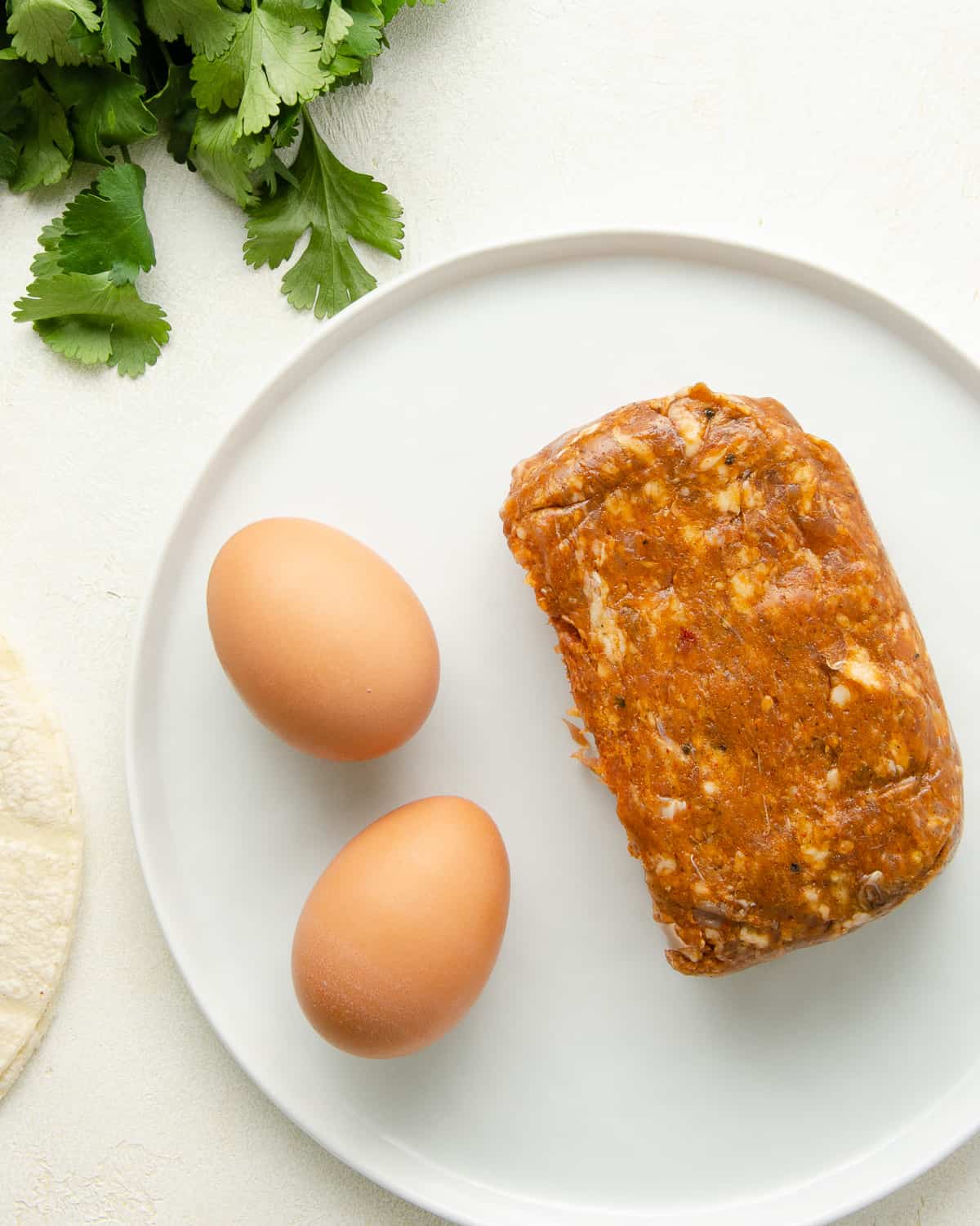 Ingredients to make huevos con chorizo, eggs and chorizo sausage.
