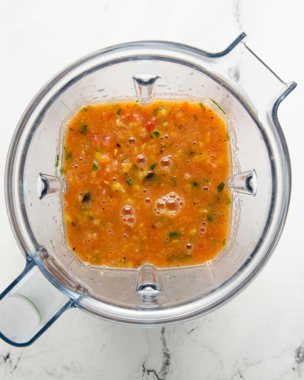 Mango habanero salsa in the blender that is fully pulsed.