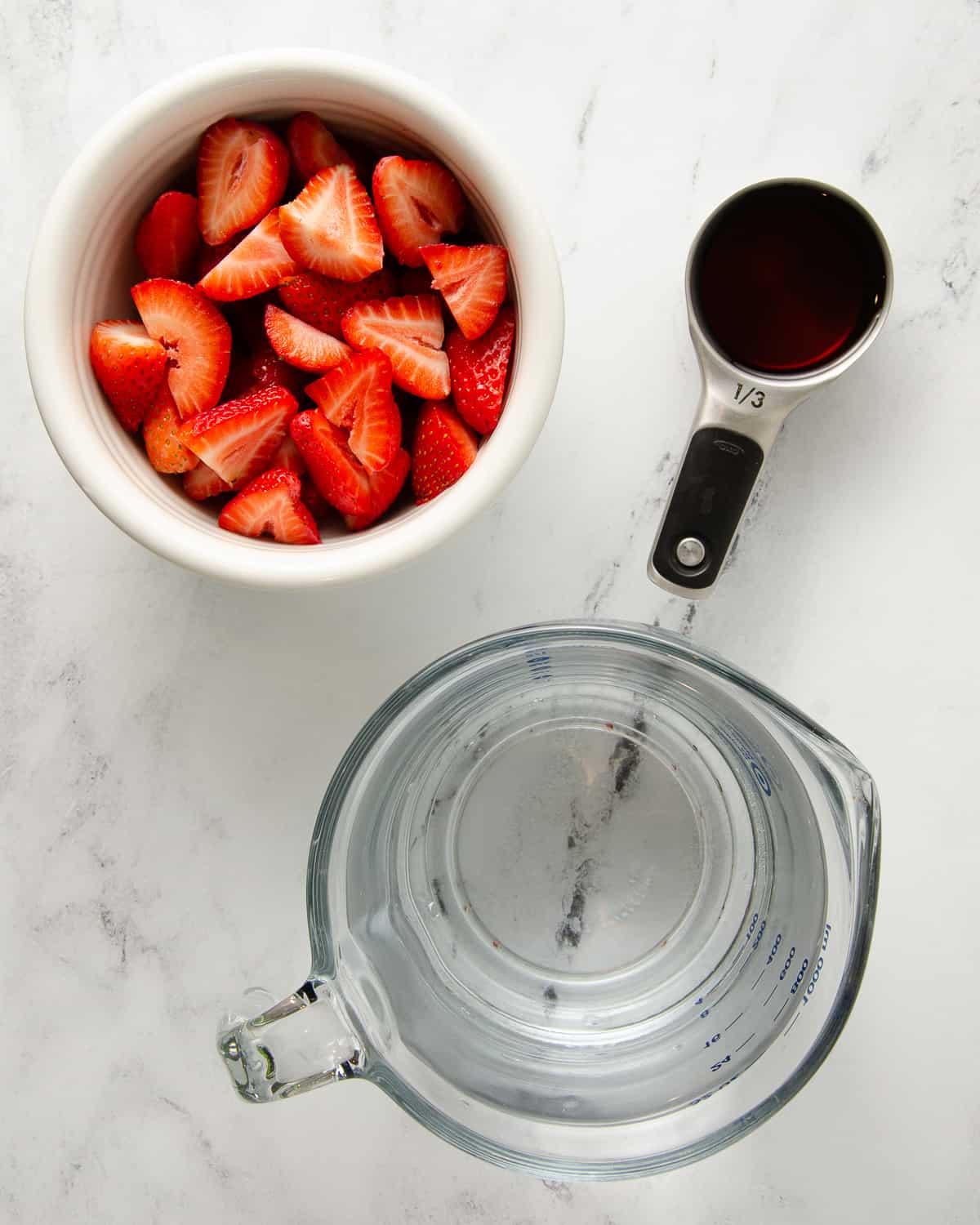 Ingredients needed for agua de fresa: water, strawberries, and sweetener.