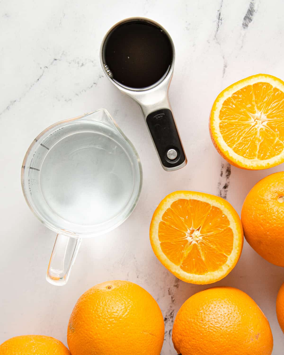Ingredients to make orange agua fresca: oranges, water and honey.