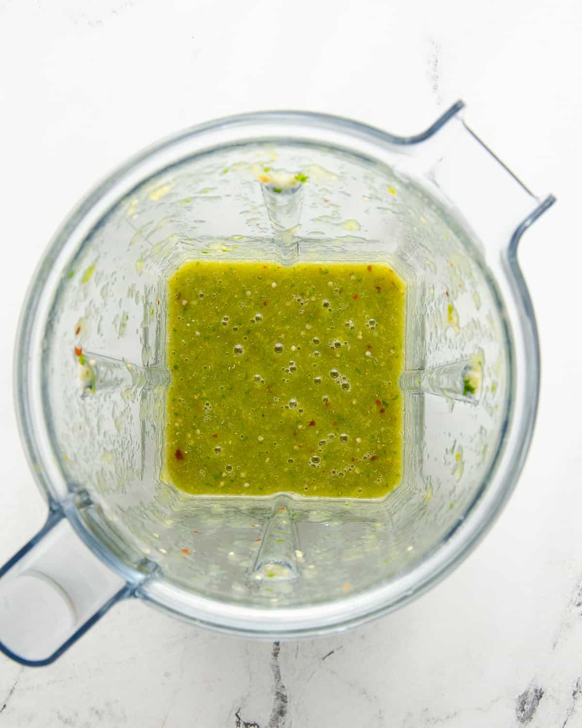 A blended green serrano salsa in the blender.