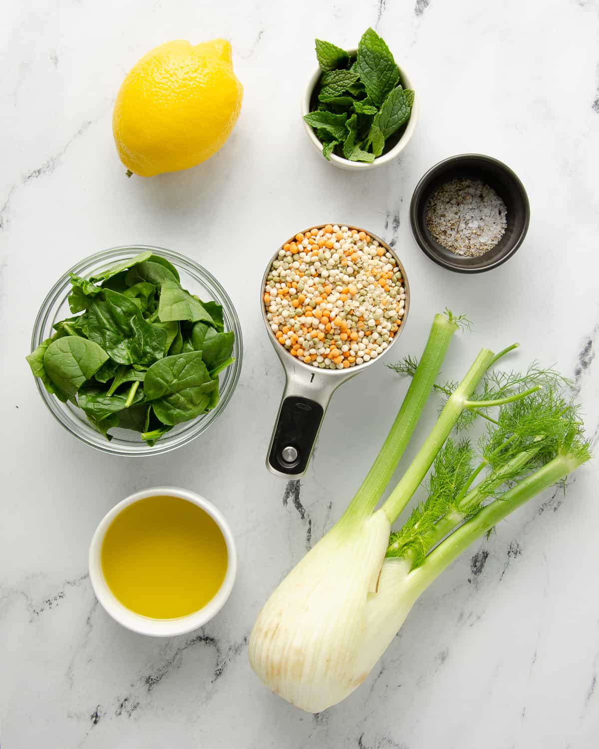 Ingredients needed to make vegan couscous salad with fennel and spinach.