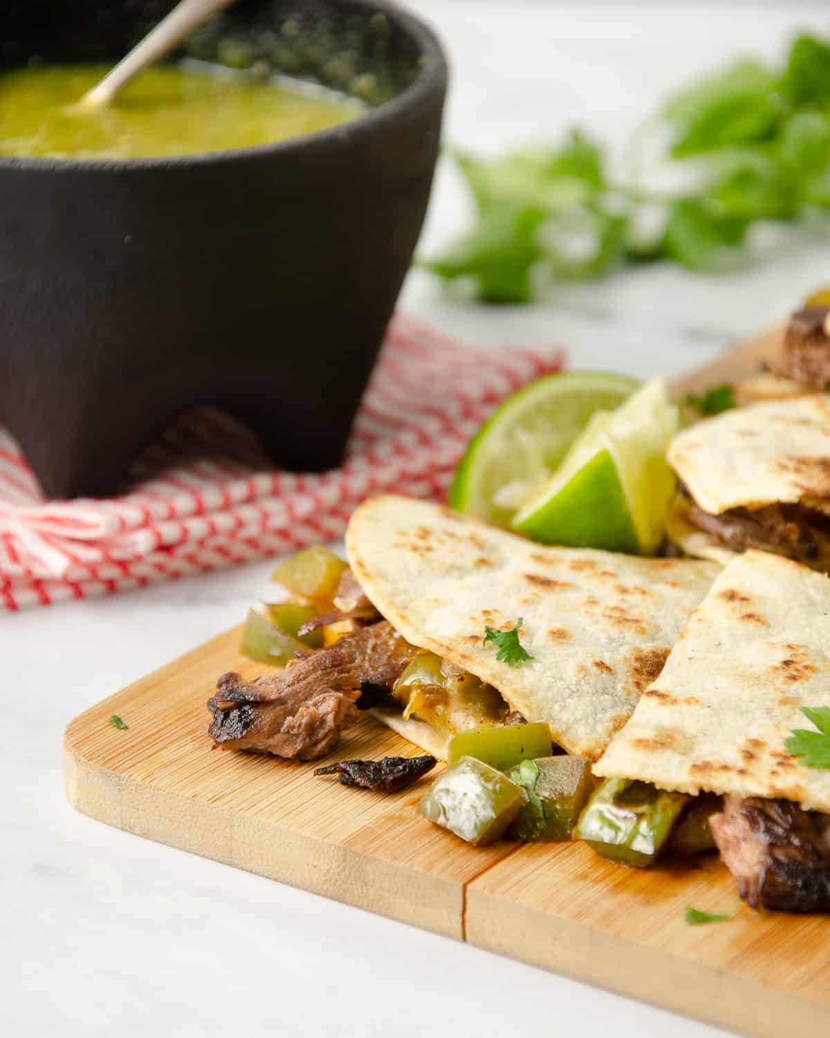 A close up view of the carne asada inside a cooked quesadilla.