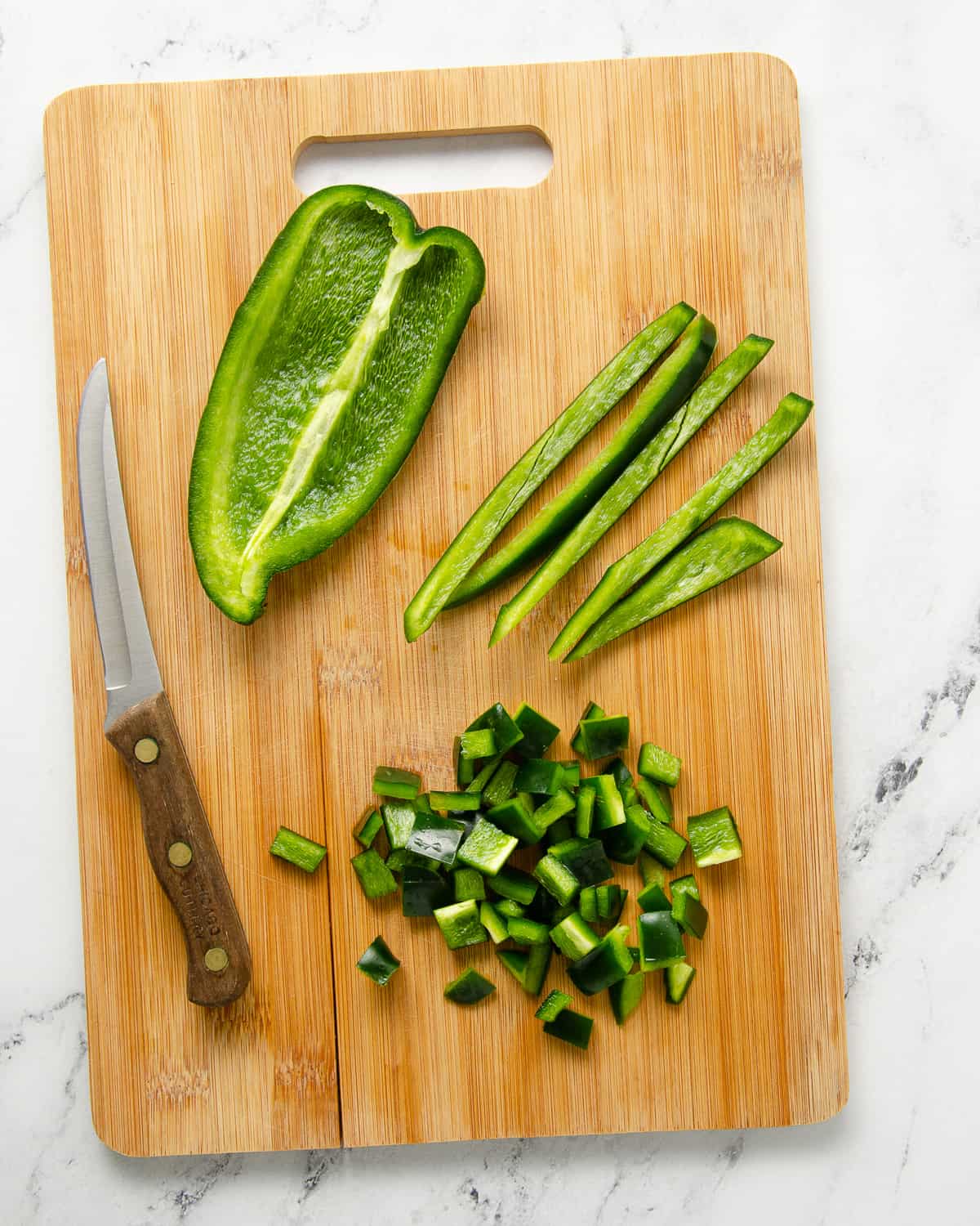 Cutting a poblano in the three stages: cutting the sides, then slicing into thin strips and then finally dicing it.
