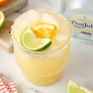 A featured image of a skinny margarita garnished with lime wedge and orange wheel.