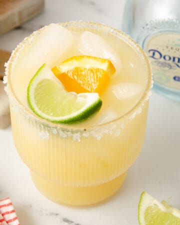 A featured image of a skinny margarita garnished with lime wedge and orange wheel.