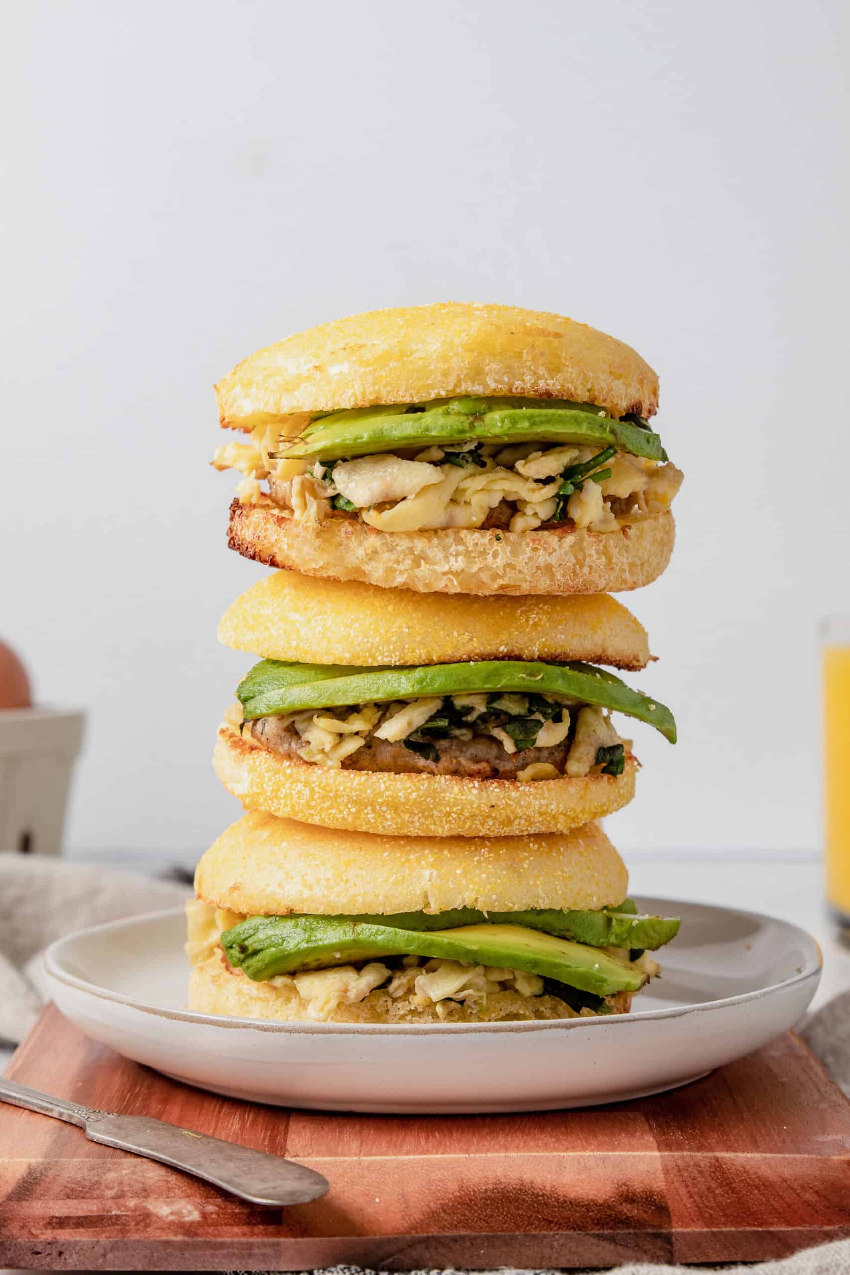 Three gluten free breakfast sandwiches stacked on top of each other.