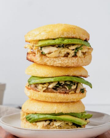 Three gluten free breakfast sandwiches stacked on top of each other.