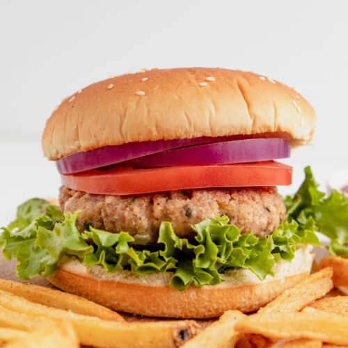 Gluten free turkey burger with lettuce, tomato, and onion served with fries.