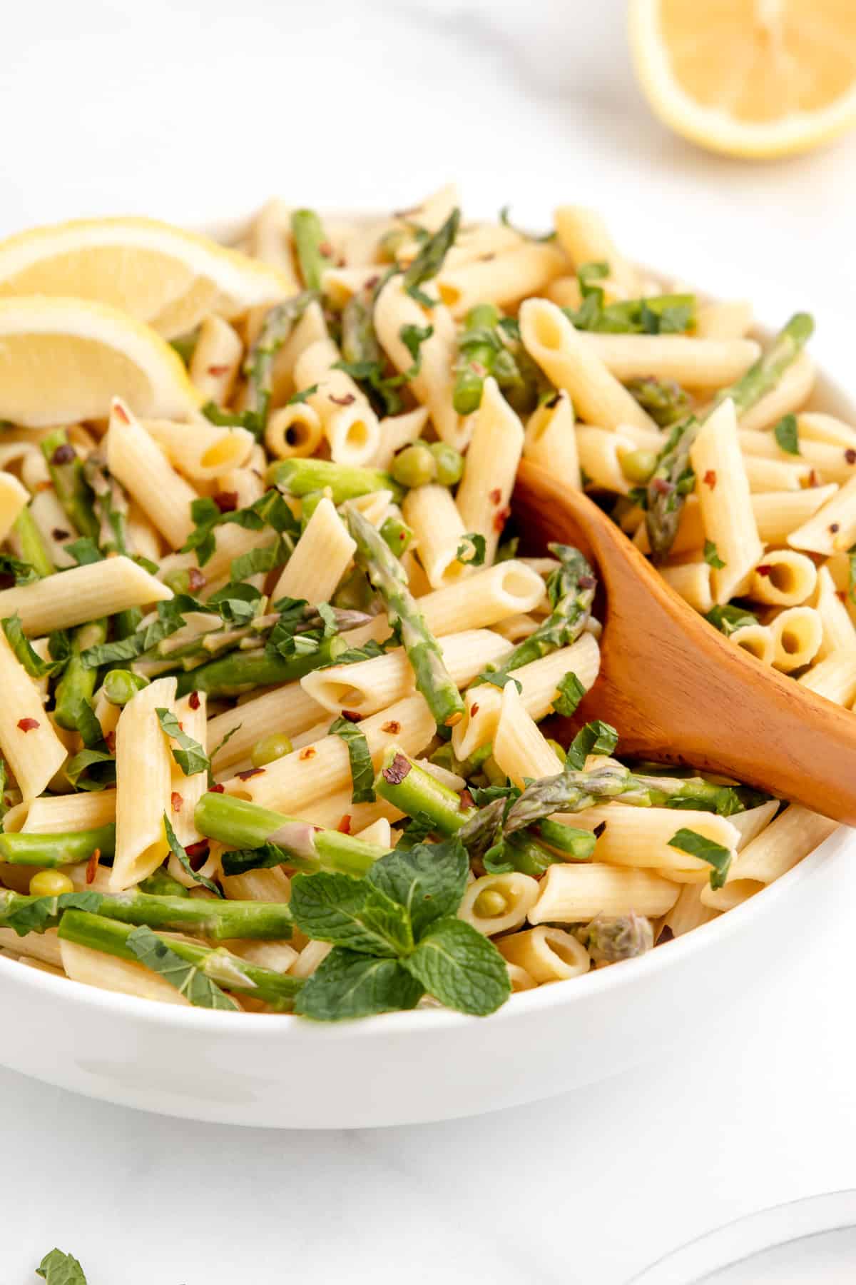 A bowl of spring vegetable pasta with lemon, butter, and mint.