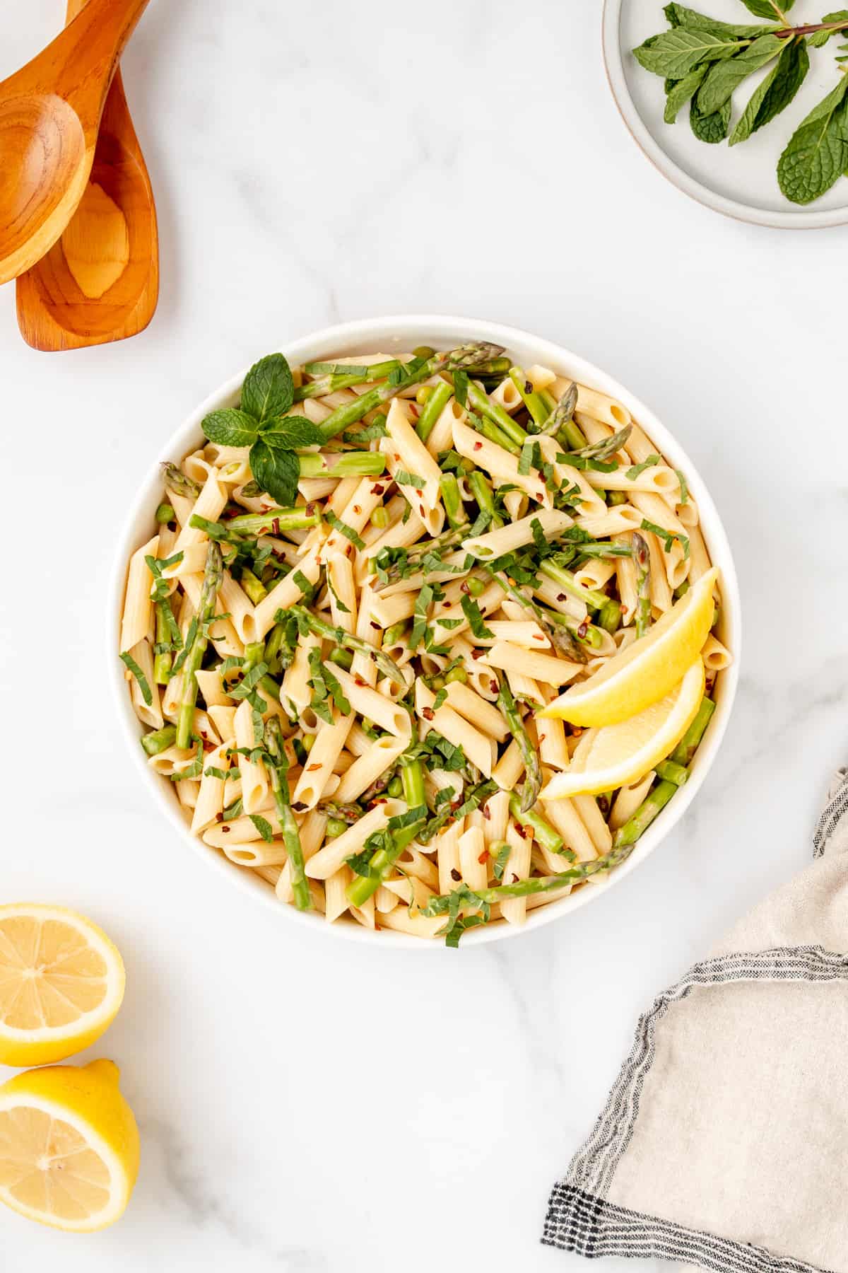 A bowl of spring vegetable gluten free pasta with lemon and butter sauce.