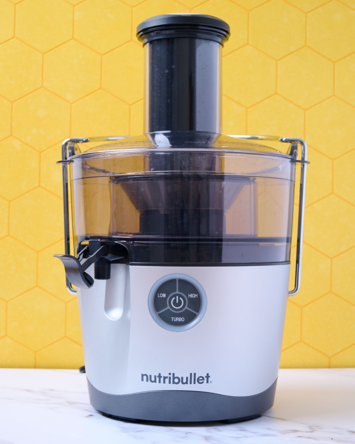 A Nutribullet juicer on a marble counter.