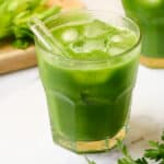 A glass of green goddess juice with apple, celery, and cucumber.