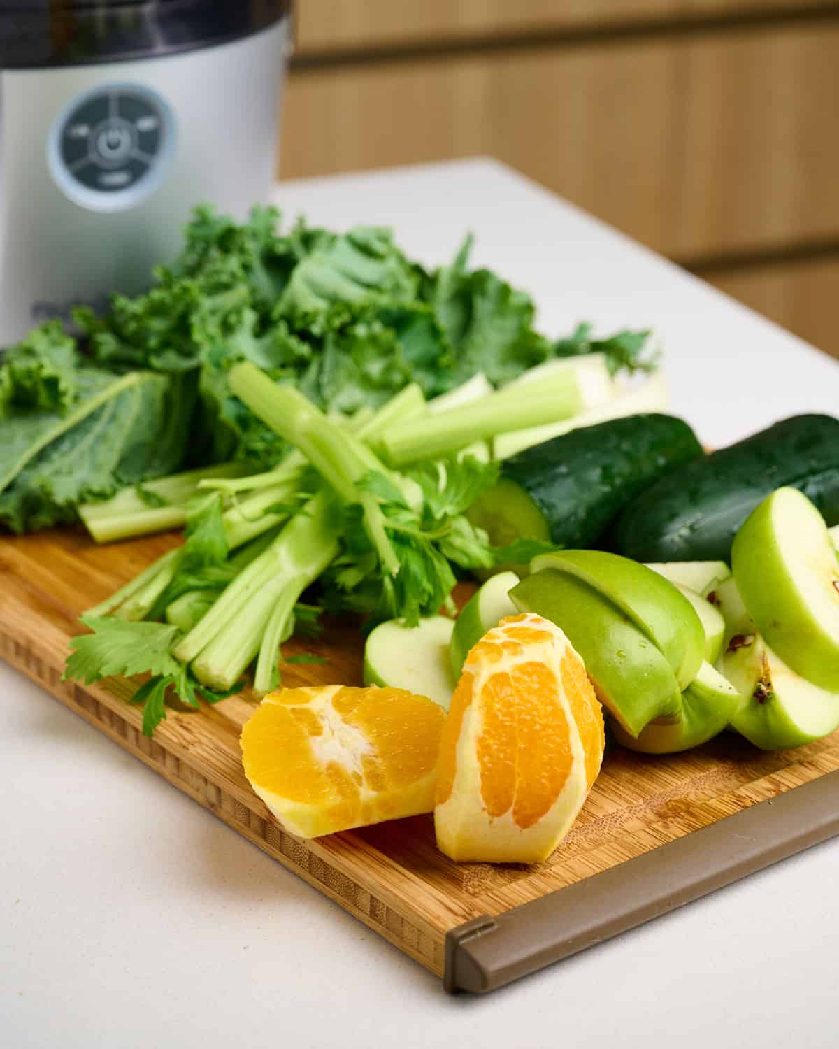 Prepped ingredients for green goddess juice on a cutting board.