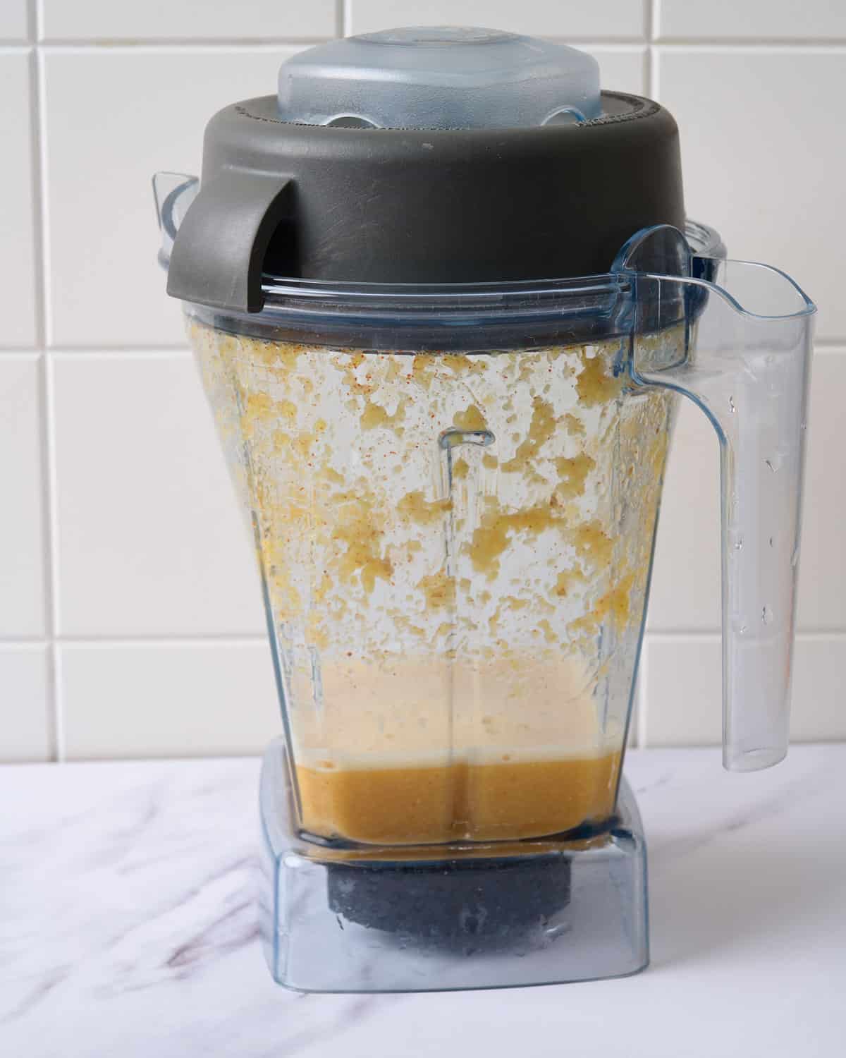 The juice of lemon ginger cayenne shots blended in a blender.