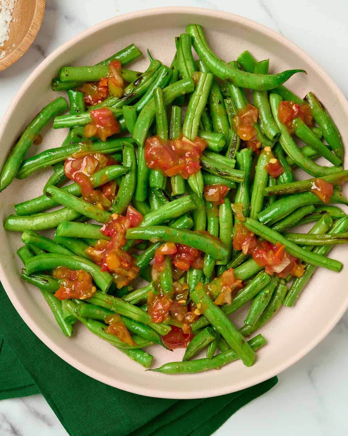 Mexican green beans with salsa on a serving plate.