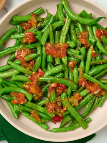 Mexican green beans with salsa in a serving plate.