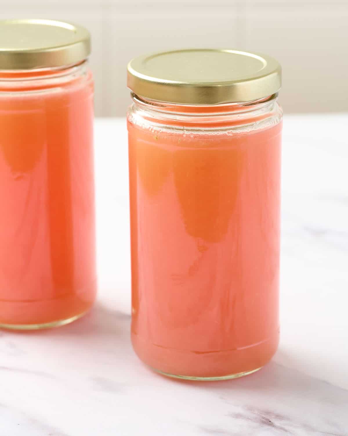 Fresh squeezed grapefruit juice in a glass container.