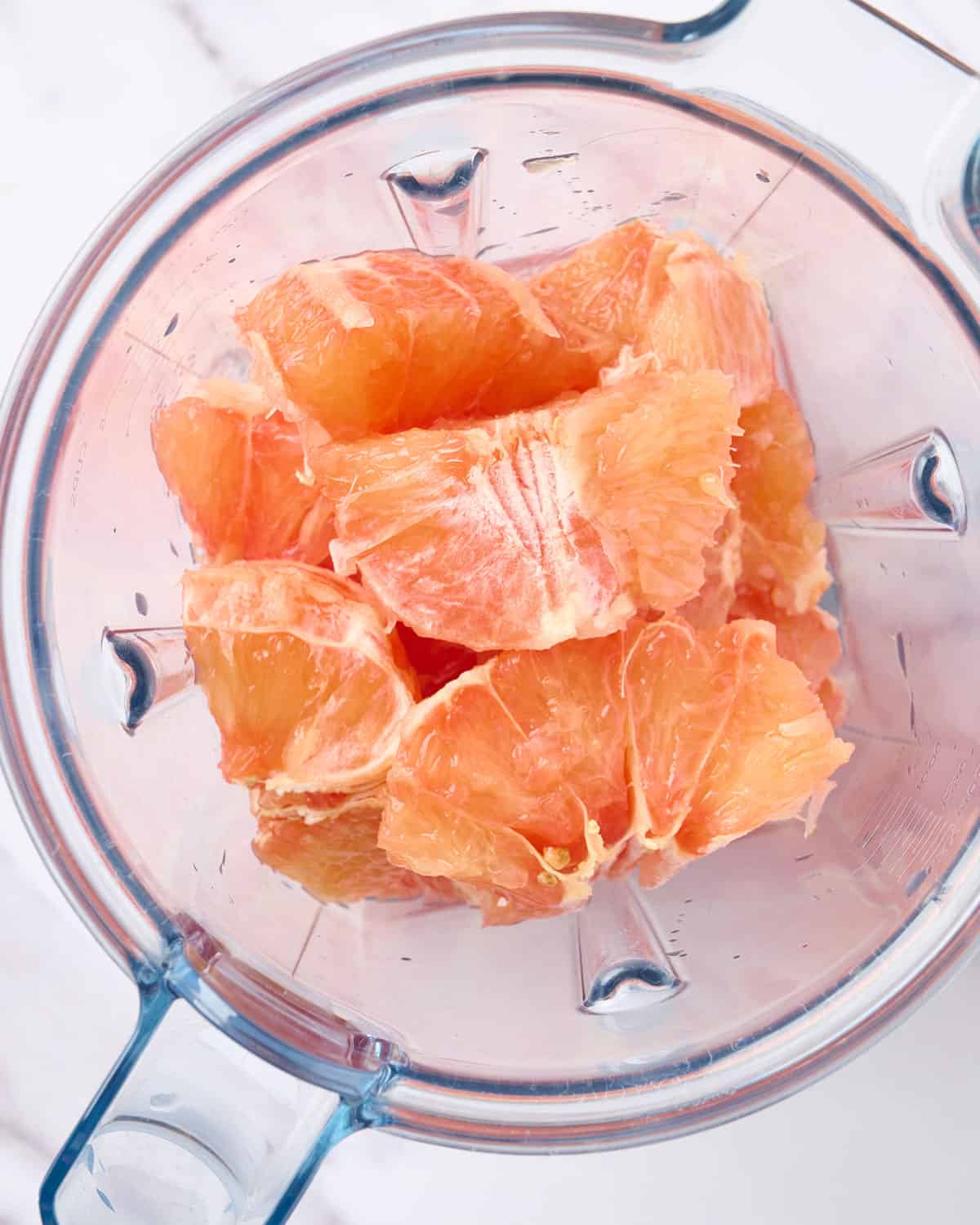 Grapefruit wedges in the blender to make freshly squeezed grapefruit juice.