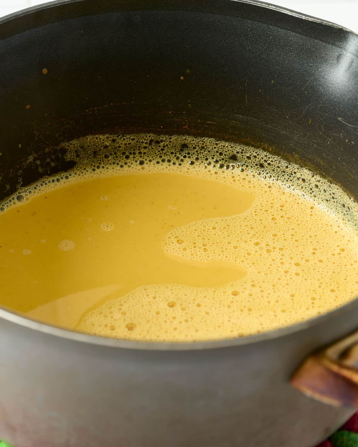 Oat milk turmeric latte in a pot.