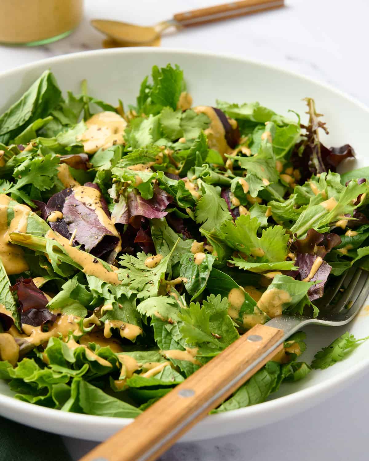 Spicy cashew butter dressing on a salad.
