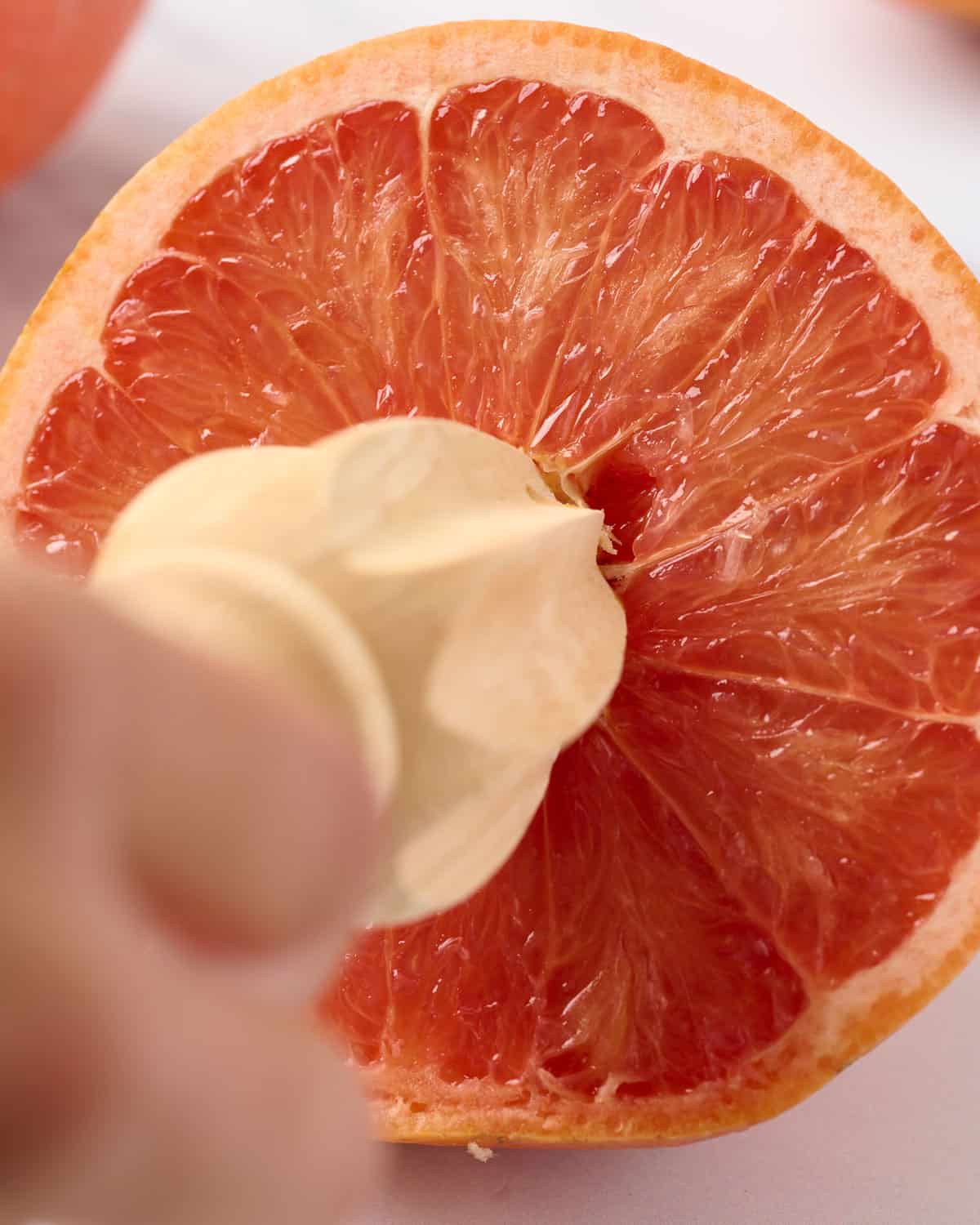 Using a citrus reamer to make freshly squeezed grapefruit juice.