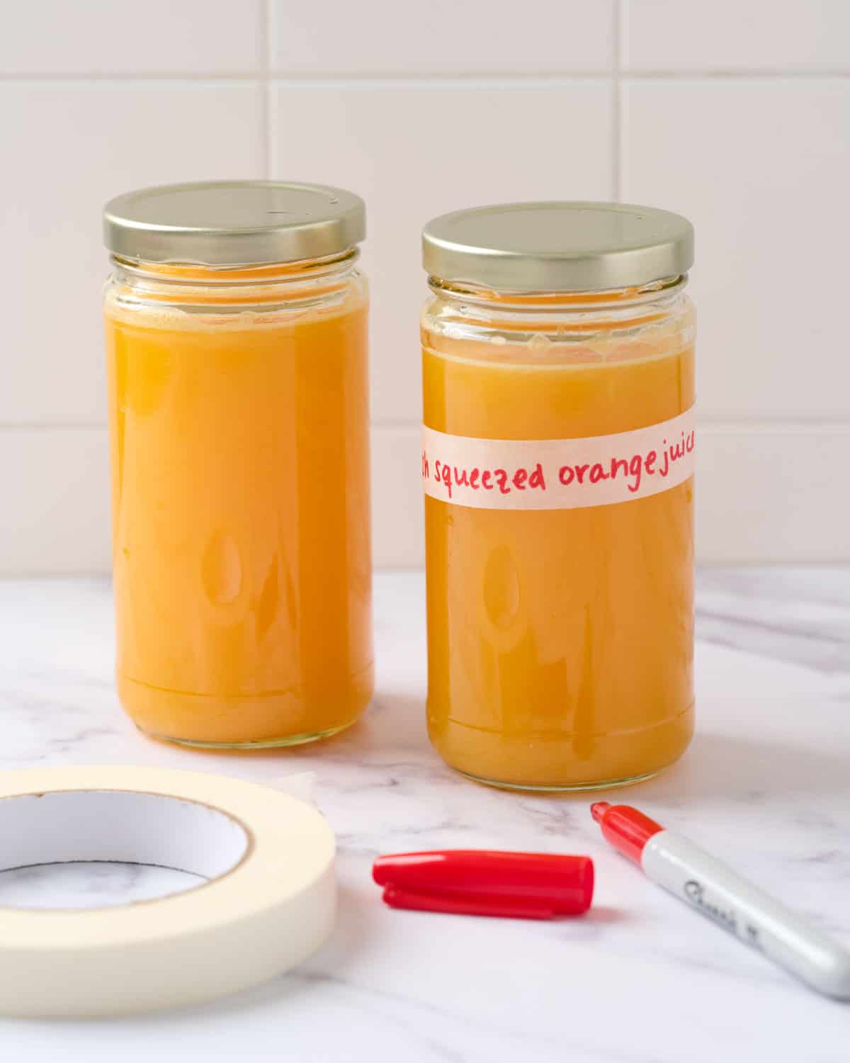 freshly squeezed orange juice stored in glass jars