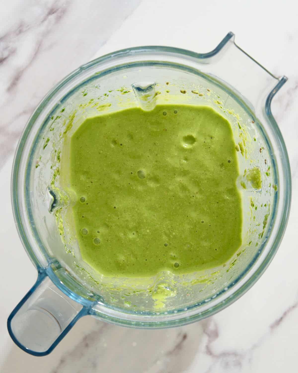 Kale and spinach smoothie blended in a blender.